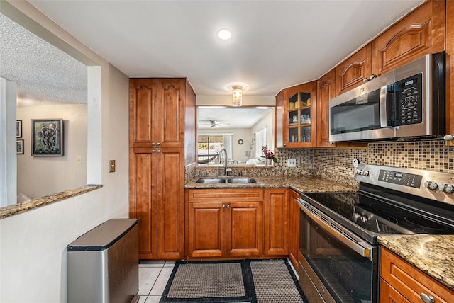 6308 Newtown Cir Unit 8C5, Tampa, FL 33615 - kitchen with brown cabinets, stainless steel appliances, and a sink