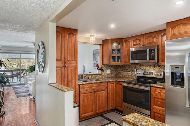 6308 Newtown Cir Unit 8C5, Tampa, FL 33615 - kitchen featuring appliances with stainless steel finishes and brown cabinetry