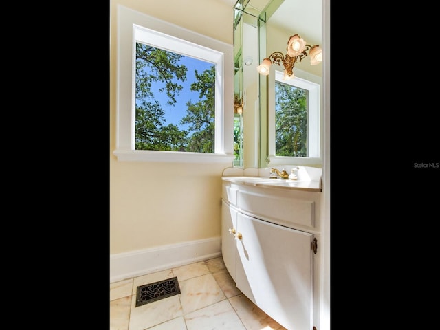 5020 S Shore Crest Cir, Tampa, FL 33609 - bathroom with tile patterned floors, visible vents, baseboards, and vanity