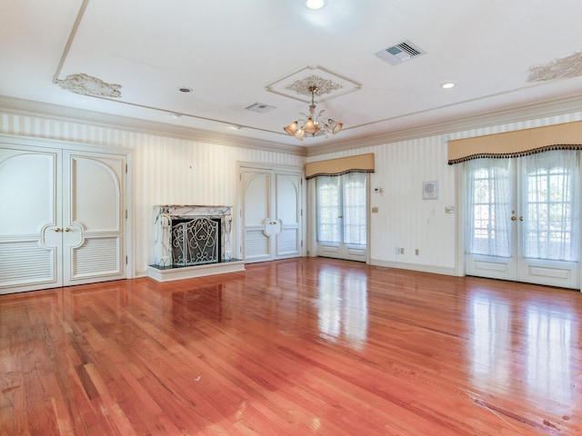 5020 S Shore Crest Cir, Tampa, FL 33609 - unfurnished living room with visible vents, a notable chandelier, wood finished floors, and french doors