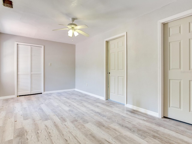 5020 S Shore Crest Cir, Tampa, FL 33609 - unfurnished bedroom featuring baseboards, a closet, light wood-style floors, and a ceiling fan