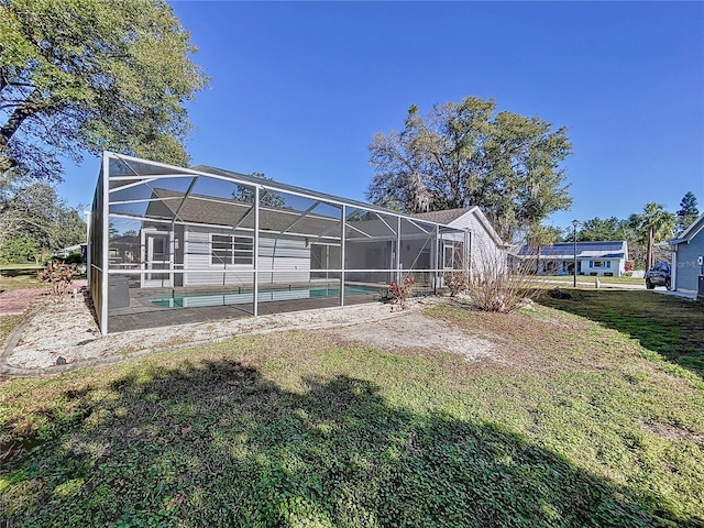 8600 Berkley Dr, Hudson, FL 34667 - back of house featuring a patio, a yard, and glass enclosure