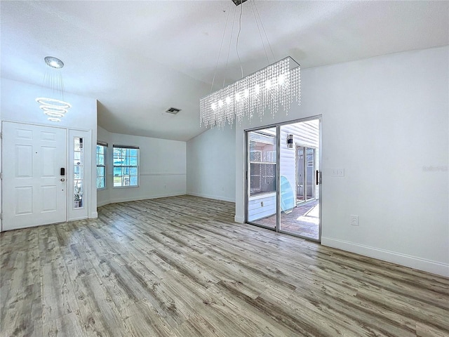 8600 Berkley Dr, Hudson, FL 34667 - interior space featuring lofted ceiling, a notable chandelier, and wood-type flooring