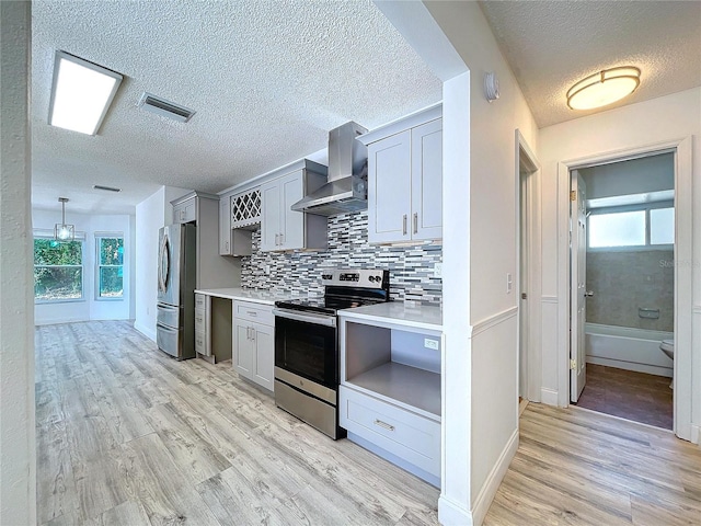 8600 Berkley Dr, Hudson, FL 34667 - kitchen featuring wall chimney range hood, gray cabinets, light hardwood / wood-style floors, and appliances with stainless steel finishes