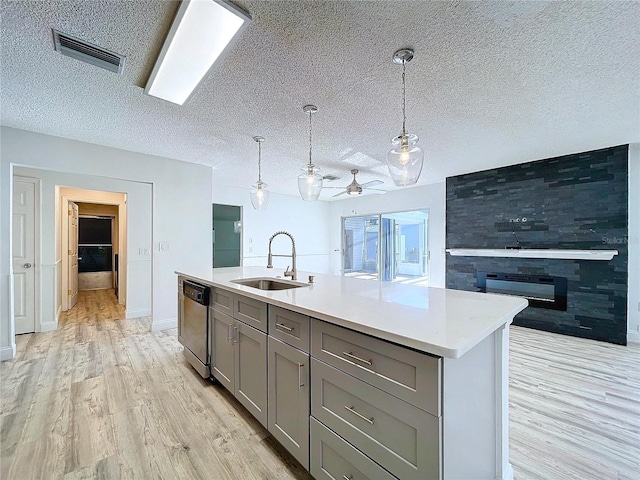 8600 Berkley Dr, Hudson, FL 34667 - kitchen featuring gray cabinets, sink, stainless steel dishwasher, and decorative light fixtures