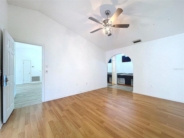 8600 Berkley Dr, Hudson, FL 34667 - empty room featuring lofted ceiling, sink, ceiling fan, and light wood-type flooring