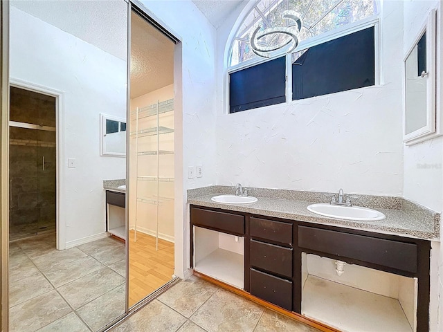 8600 Berkley Dr, Hudson, FL 34667 - bathroom featuring tile patterned floors, vanity, and a textured ceiling