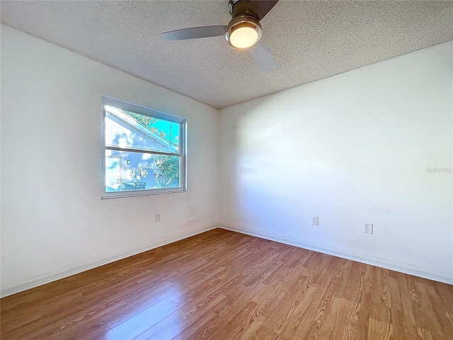 8600 Berkley Dr, Hudson, FL 34667 - empty room featuring ceiling fan, light hardwood / wood-style floors, and a textured ceiling