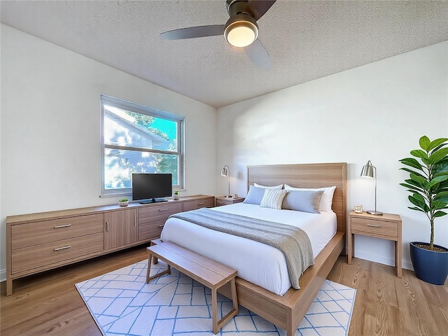 8600 Berkley Dr, Hudson, FL 34667 - bedroom with ceiling fan, a textured ceiling, and light wood-type flooring