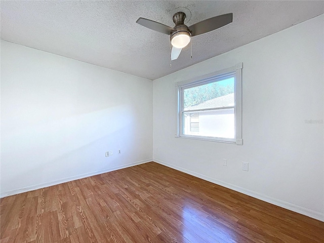 8600 Berkley Dr, Hudson, FL 34667 - unfurnished room featuring wood-type flooring, ceiling fan, and a textured ceiling