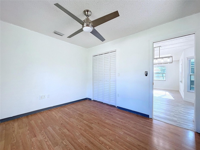 8600 Berkley Dr, Hudson, FL 34667 - unfurnished bedroom with ceiling fan, dark wood-type flooring, a textured ceiling, and a closet