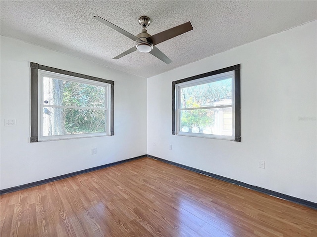 8600 Berkley Dr, Hudson, FL 34667 - empty room featuring hardwood / wood-style floors, a textured ceiling, and ceiling fan