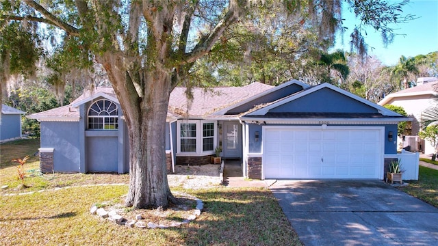 ranch-style house featuring a garage and a front yard