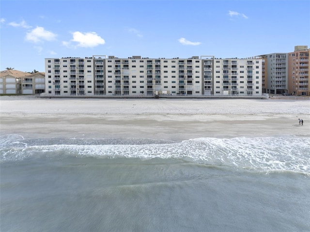 view of property with a beach view and a water view