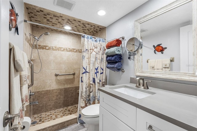 bathroom with vanity, a shower with shower curtain, and toilet