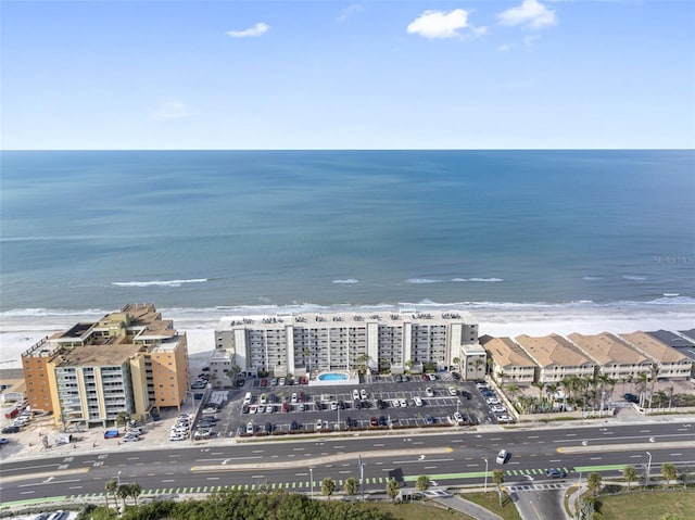 birds eye view of property with a water view and a view of the beach