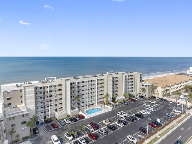 birds eye view of property with a beach view and a water view