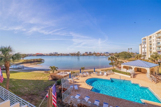 community pool with a lawn, a patio, a water view, fence, and a gazebo