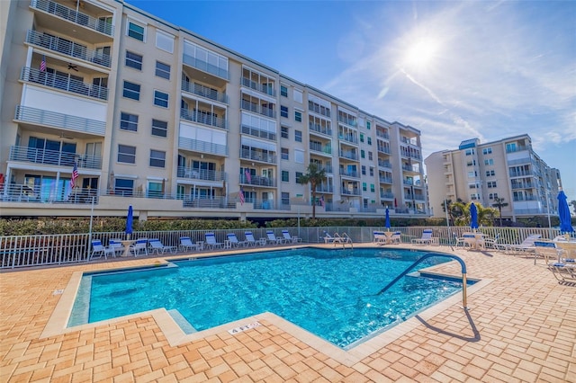 pool with fence and a patio