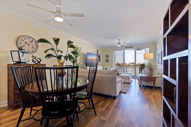 dining room with ceiling fan, ornamental molding, and dark wood-style floors