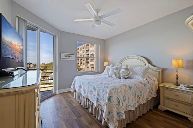 bedroom featuring dark wood-type flooring, a ceiling fan, baseboards, and access to exterior