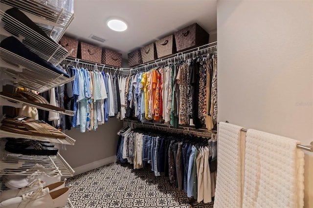 walk in closet with carpet floors and visible vents