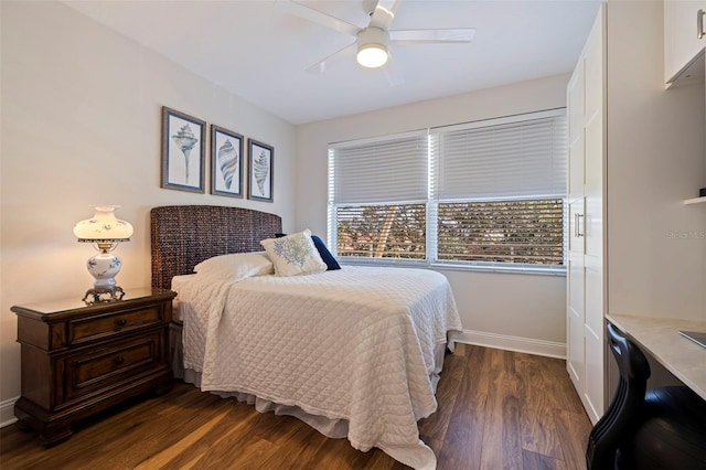bedroom featuring dark wood-style flooring, baseboards, and ceiling fan
