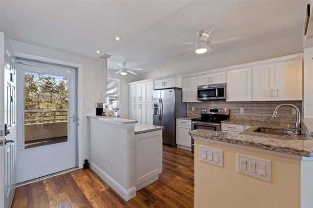 7902 Sailboat Key Blvd S Unit 206, South Pasadena, FL 33707 - kitchen with stainless steel appliances, a peninsula, a sink, a ceiling fan, and tasteful backsplash