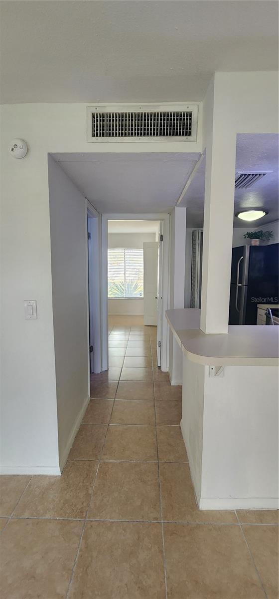 hallway with light tile patterned floors