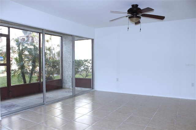 empty room with tile patterned floors and ceiling fan