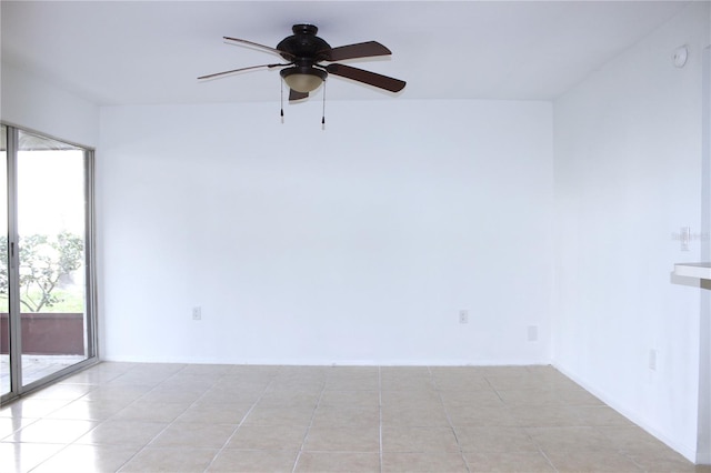 tiled spare room featuring ceiling fan