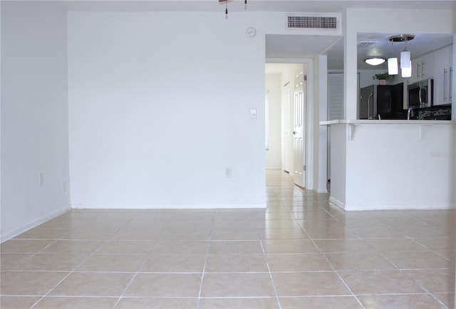 empty room with light tile patterned floors