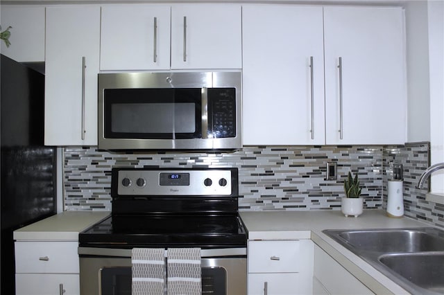 kitchen featuring tasteful backsplash, sink, stainless steel appliances, and white cabinets