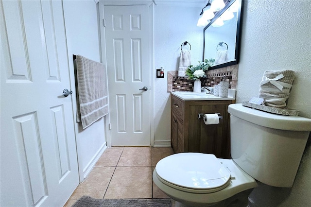 bathroom featuring tile patterned flooring, vanity, toilet, and decorative backsplash