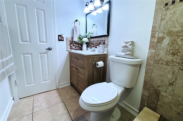 bathroom with vanity, toilet, and tile patterned flooring