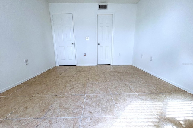 unfurnished bedroom with light tile patterned floors