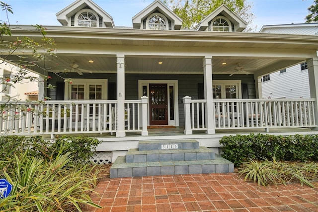 view of exterior entry featuring covered porch and ceiling fan