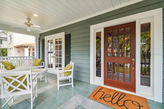 property entrance featuring a porch and ceiling fan