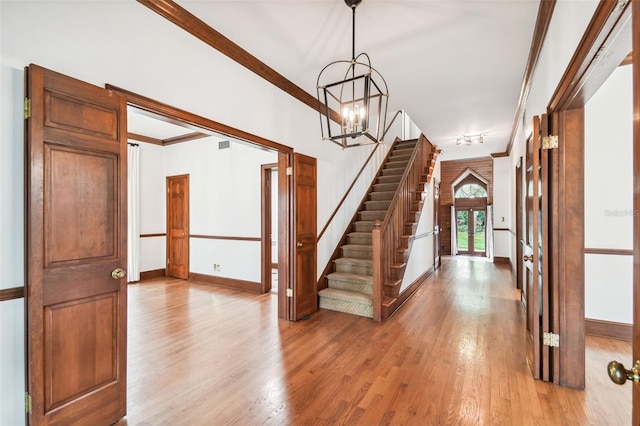 foyer featuring crown molding and light wood-type flooring