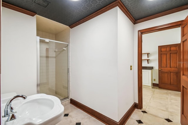 bathroom featuring crown molding, sink, tile patterned flooring, and a shower with door