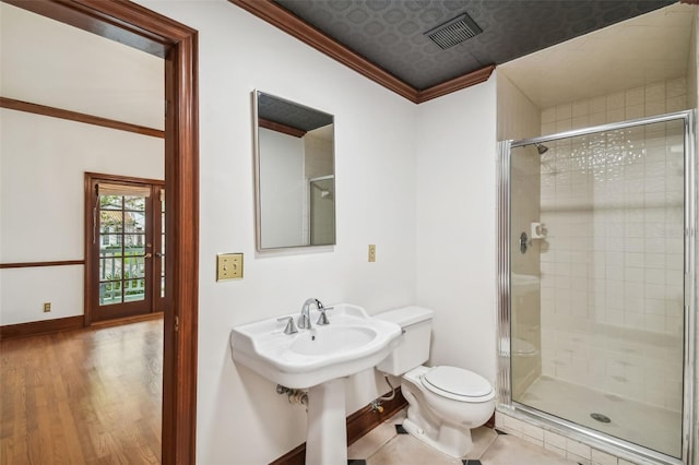 bathroom with sink, hardwood / wood-style flooring, an enclosed shower, ornamental molding, and toilet