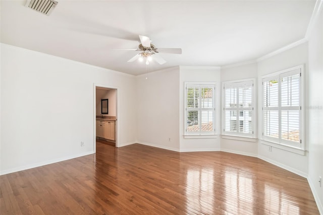 empty room featuring ceiling fan, ornamental molding, wood-type flooring, and plenty of natural light