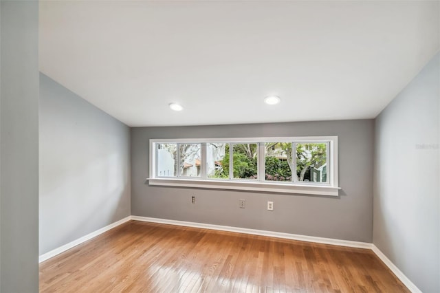 unfurnished room with plenty of natural light and light hardwood / wood-style flooring