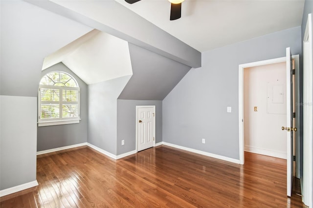 additional living space with vaulted ceiling with beams, dark wood-type flooring, and ceiling fan