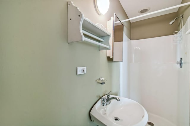 bathroom with walk in shower and sink