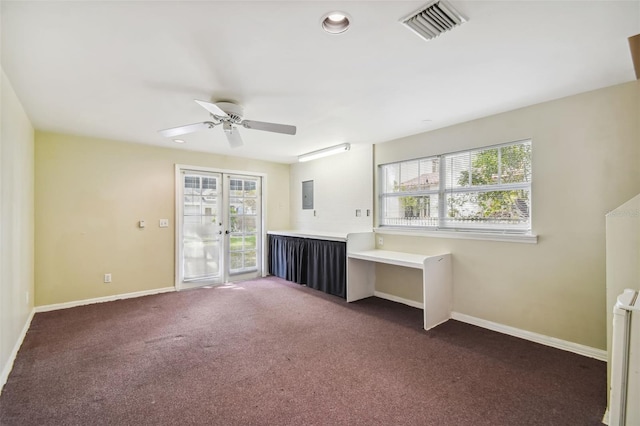 interior space with radiator, dark carpet, plenty of natural light, and french doors