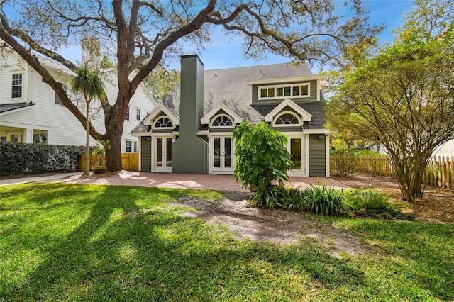 back of house with a yard, a patio area, and french doors