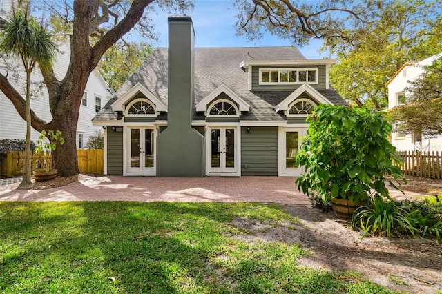 back of house featuring a lawn, a patio area, and french doors