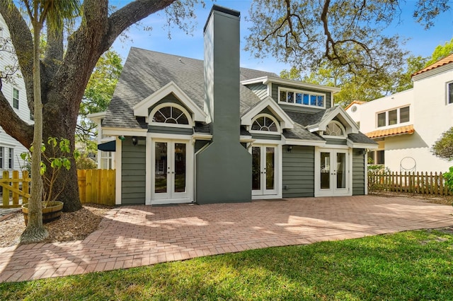 back of property with french doors, a yard, and a patio