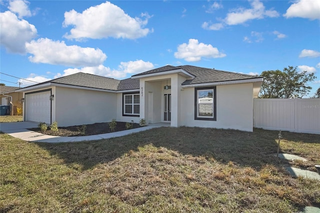 view of front of house with an attached garage, a front yard, fence, and stucco siding